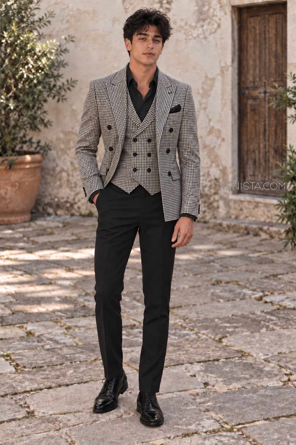 Evaristo black ivory houndstooth double-breasted 3PC suit with matching vest and plain black trousers, front view on Bruce.