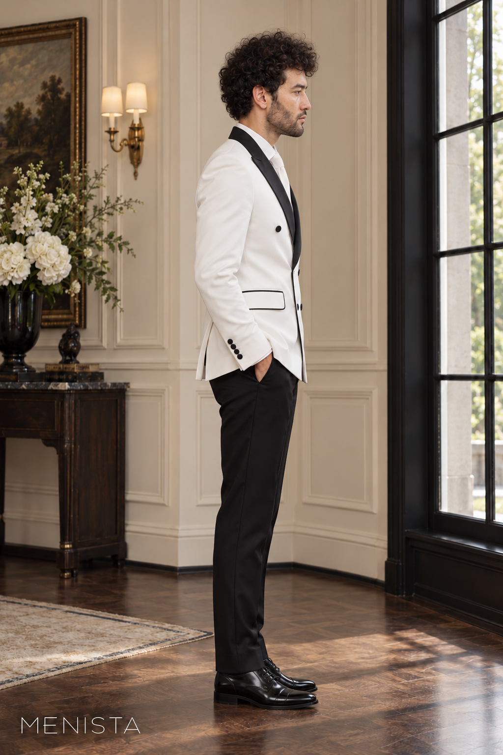 Side view of Menista white double-breasted tuxedo jacket showing black peak lapels, piping and tailored black trousers.