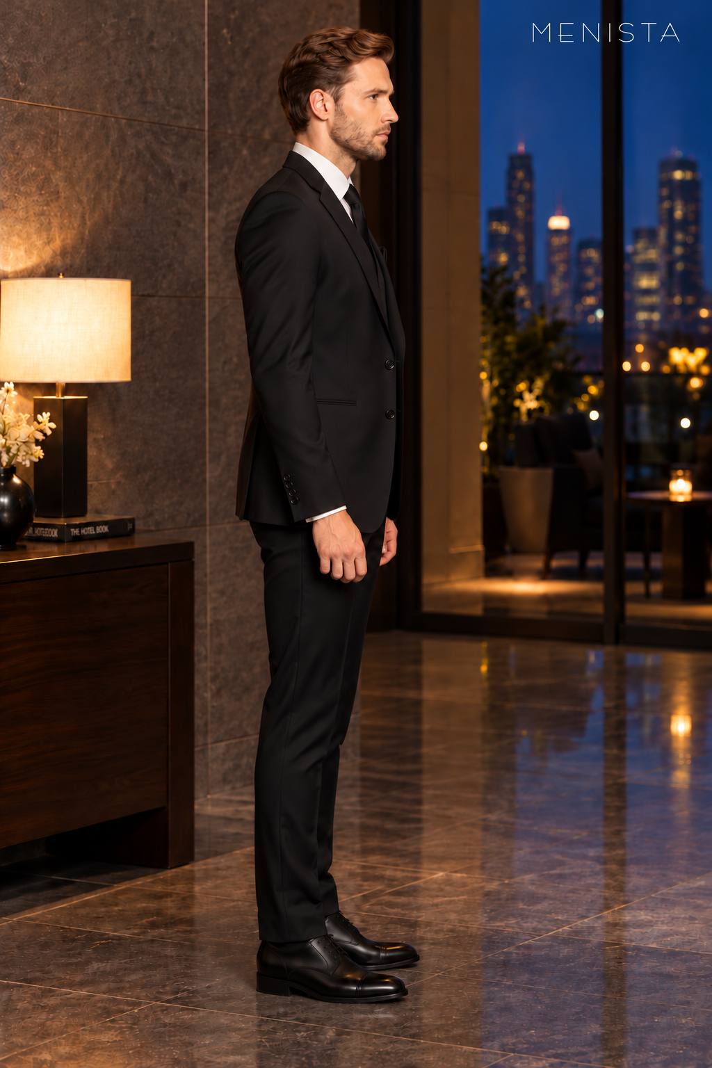 Side profile of Menista black notch-lapel suit showing slim tailored silhouette.