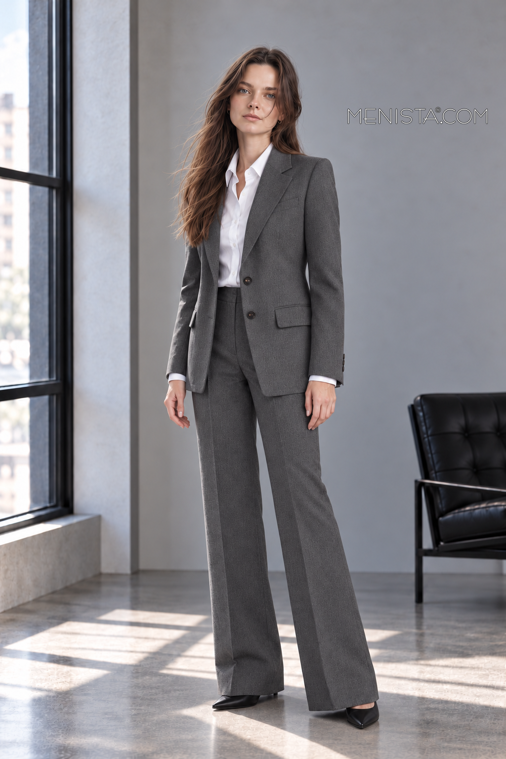 Three-quarter view of Elowen’s charcoal melange two-button jacket and matching wide-leg trousers.