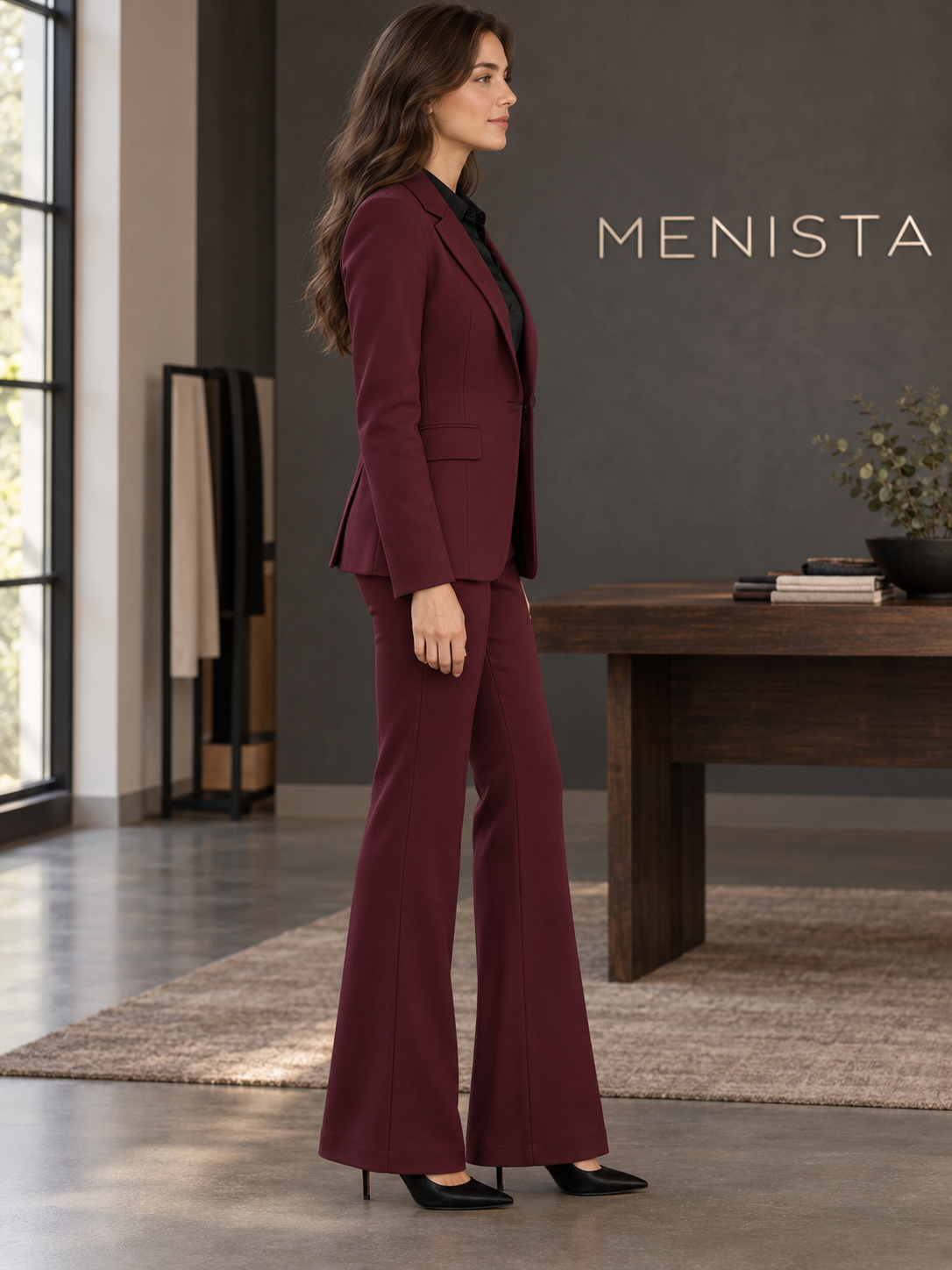 Side view of women’s burgundy single-button jacket and matching flared trousers.