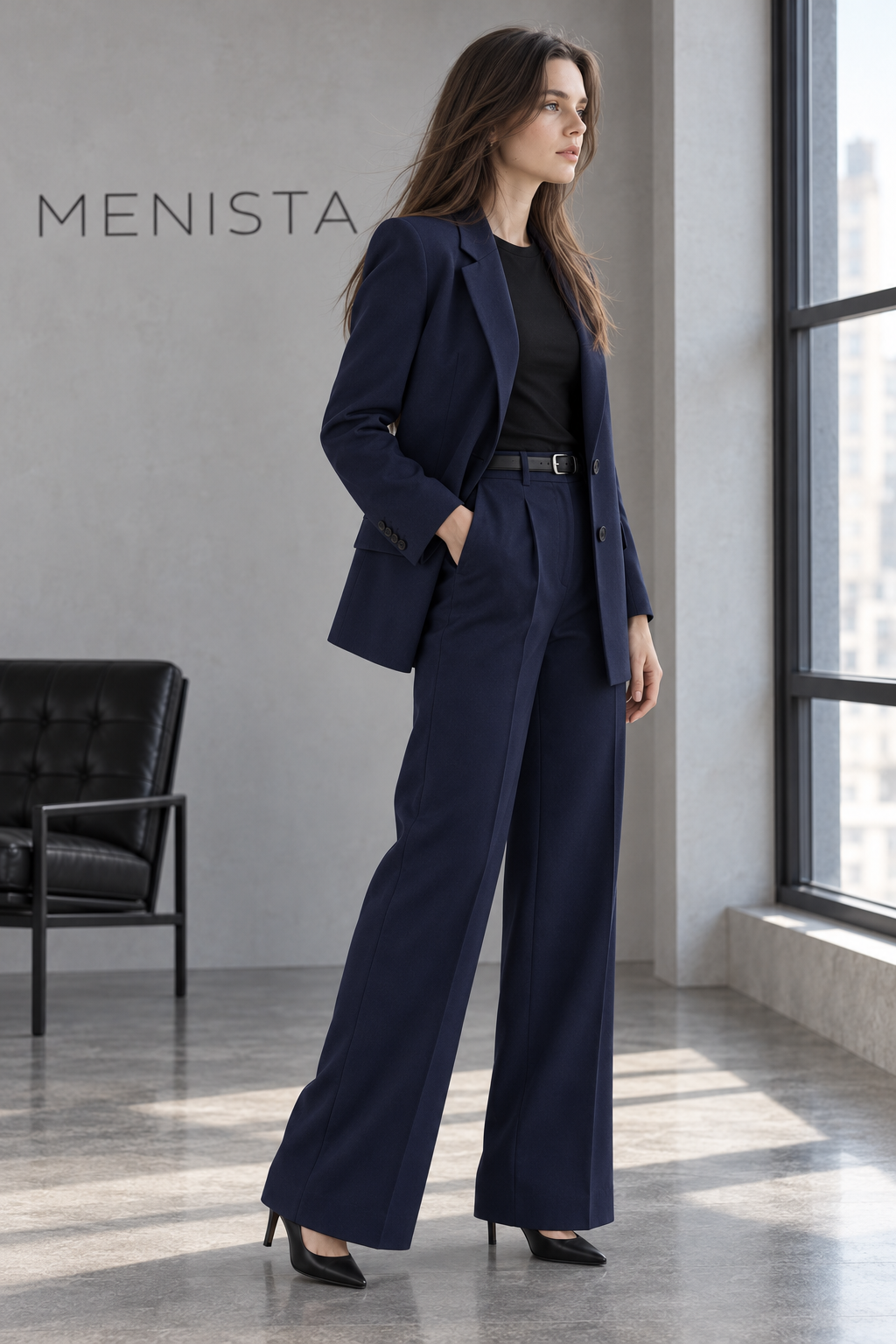 Three-quarter view of the navy two-button women’s blazer and pleated wide-leg trousers.