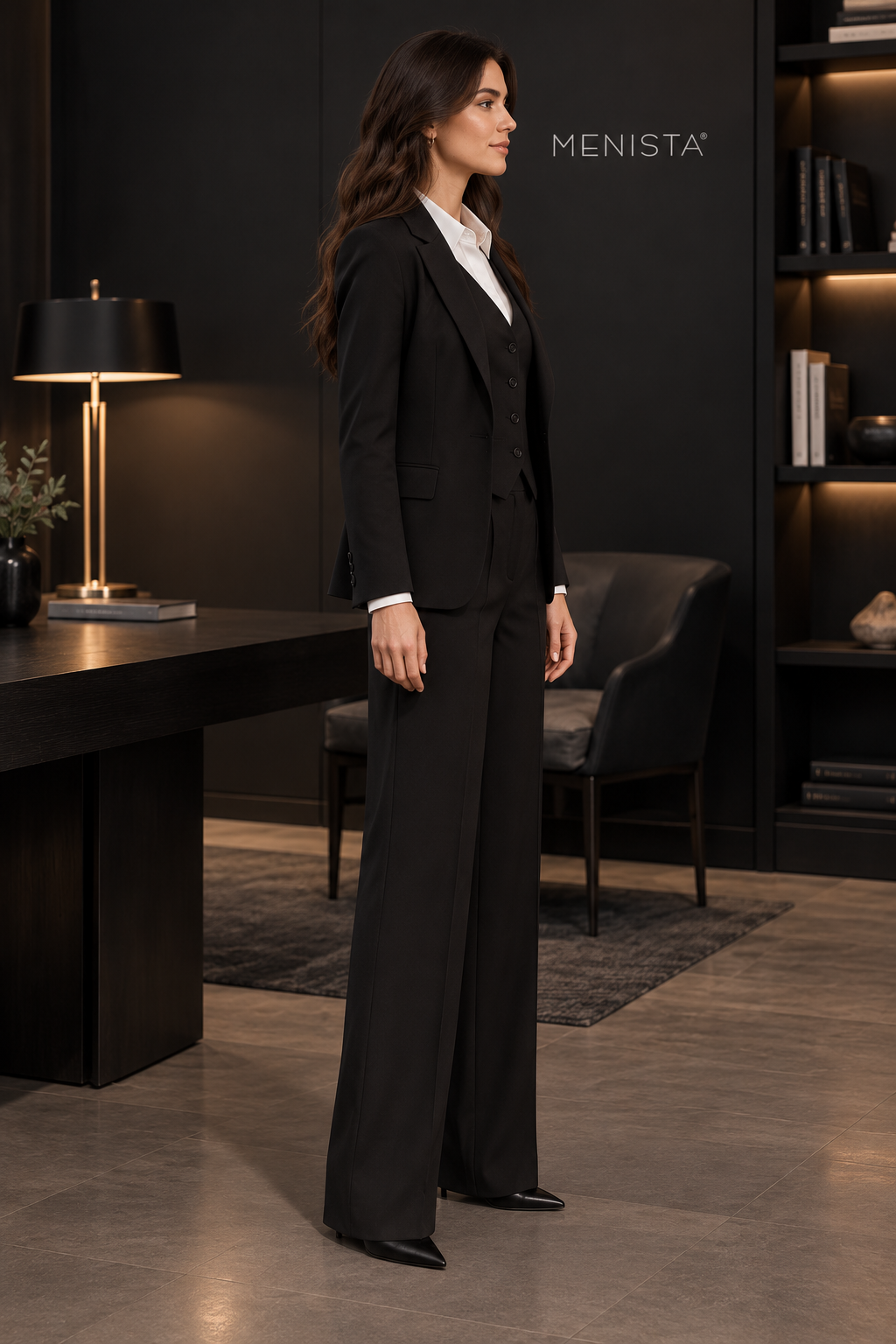 Side view of women’s black notch-lapel jacket, four-button waistcoat and matching wide-leg trousers.