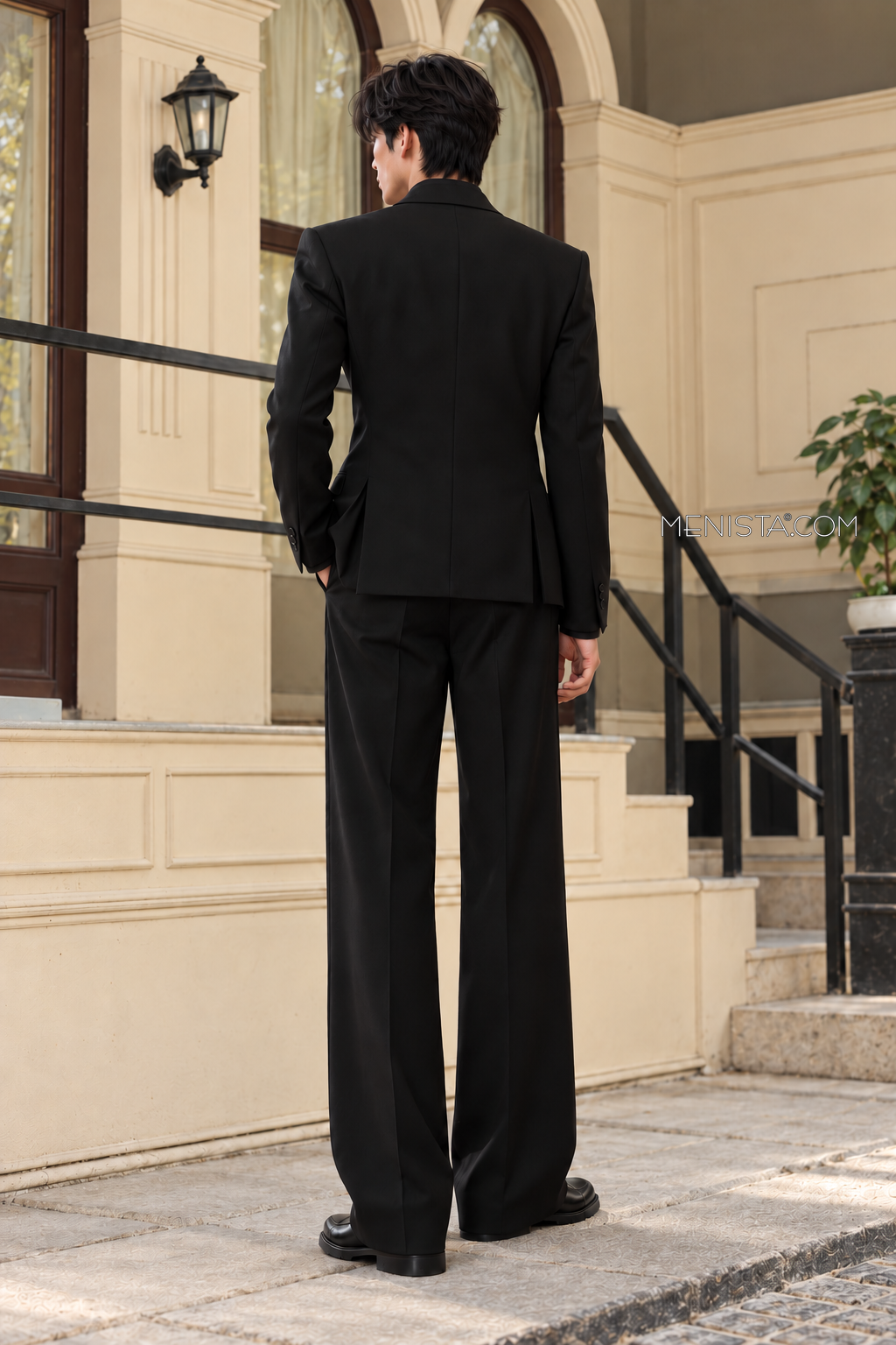 Back view of the Caldric black jacket with twin side vents and matching straight-leg trousers.