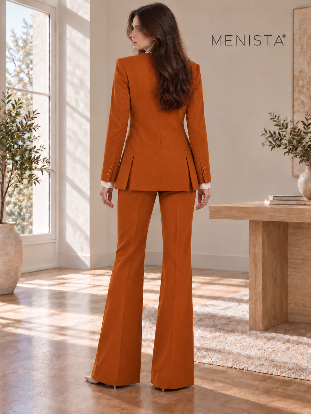Rear view of Sofia wearing women’s burnt-orange jacket, four-button waistcoat and matching flared trousers, showing twin side vents.