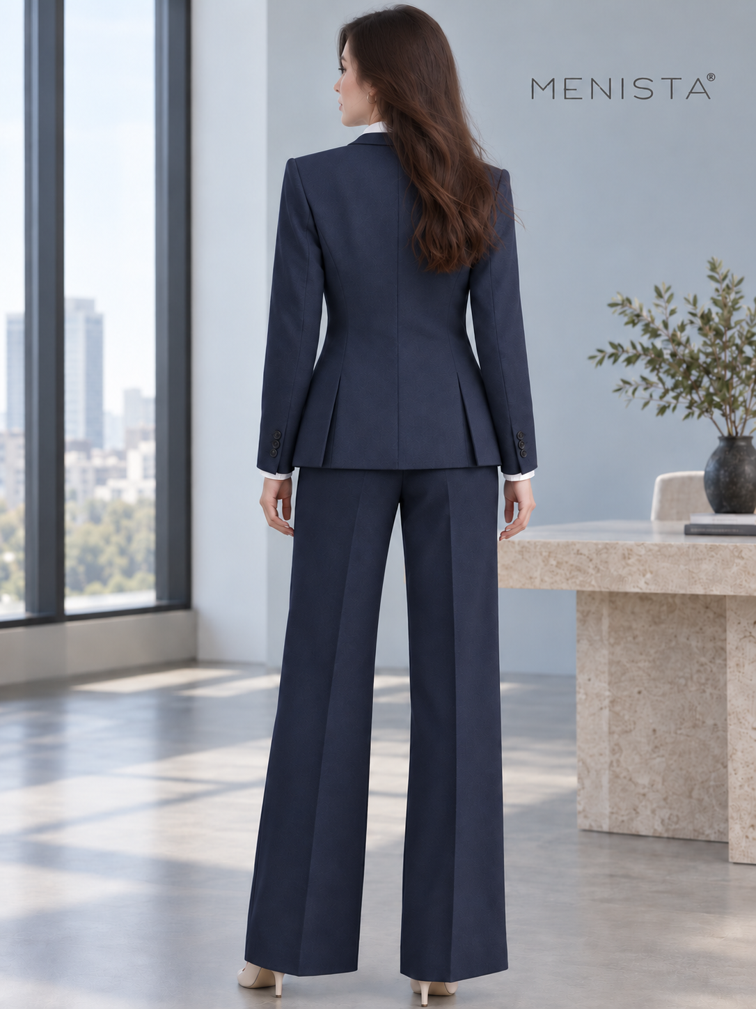 Rear view of Sofia wearing women’s navy two-button jacket, four-button waistcoat and matching wide-leg trousers, showing twin side vents.
