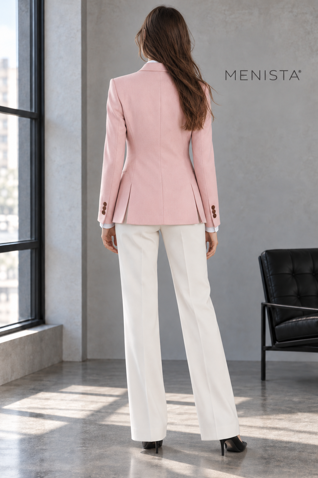 Back view of Cressida’s blush-pink tailored jacket with twin side vents and ivory straight-leg trousers.