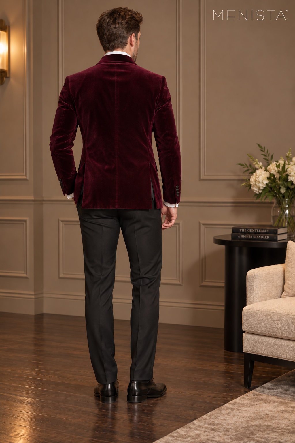 Rear view of Menista maroon velvet jacket with a maroon collar, twin side vents and black trousers.