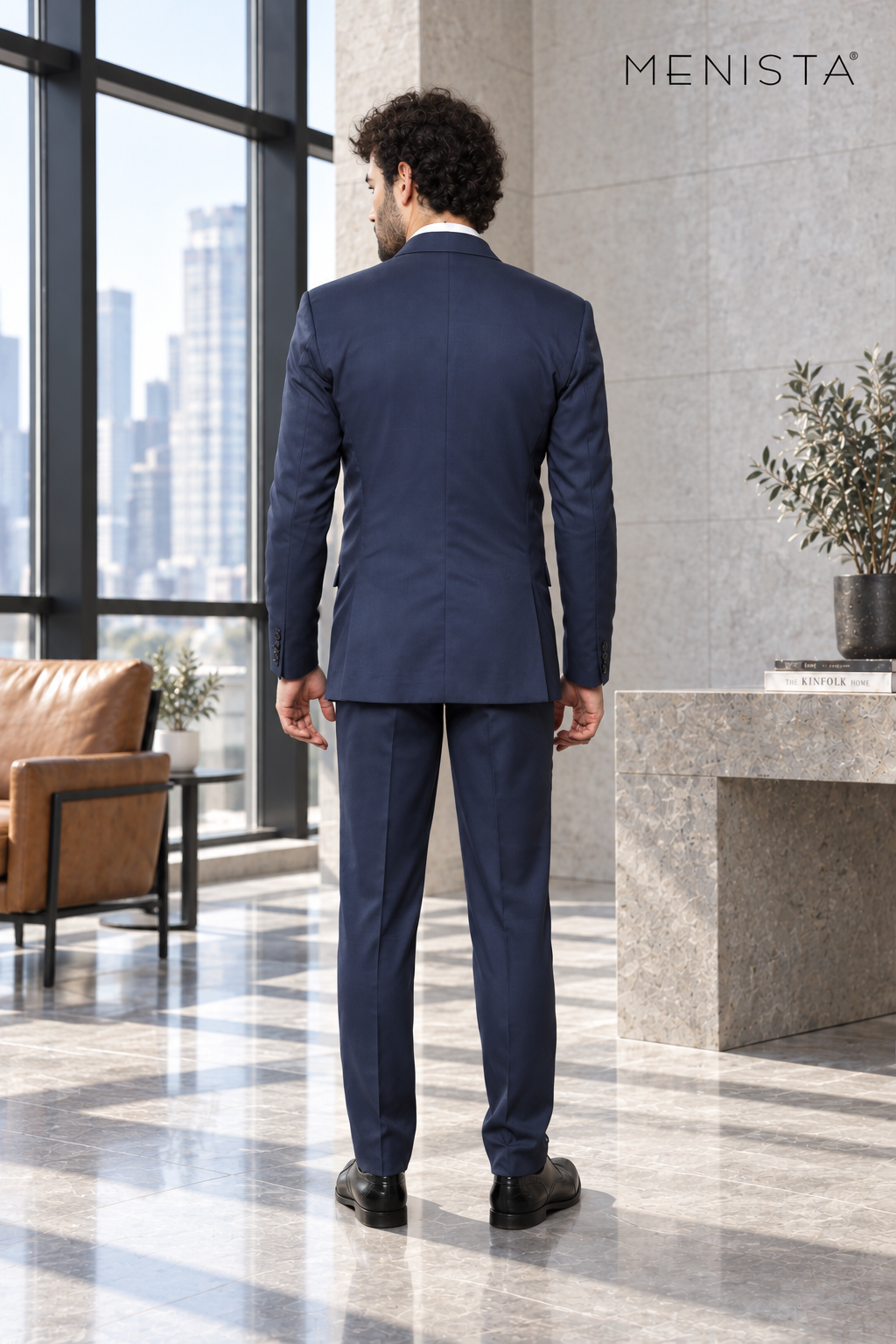 Back view of Menista navy jacket with twin side vents and matching tailored trousers.