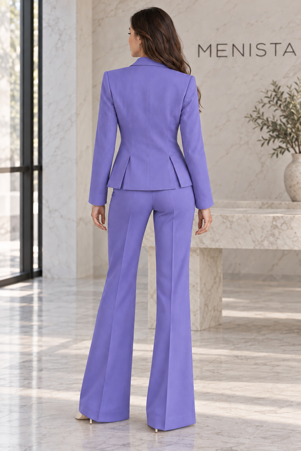 Rear view of women’s periwinkle single-button jacket and matching flared trousers, showing the jacket’s twin side vents.