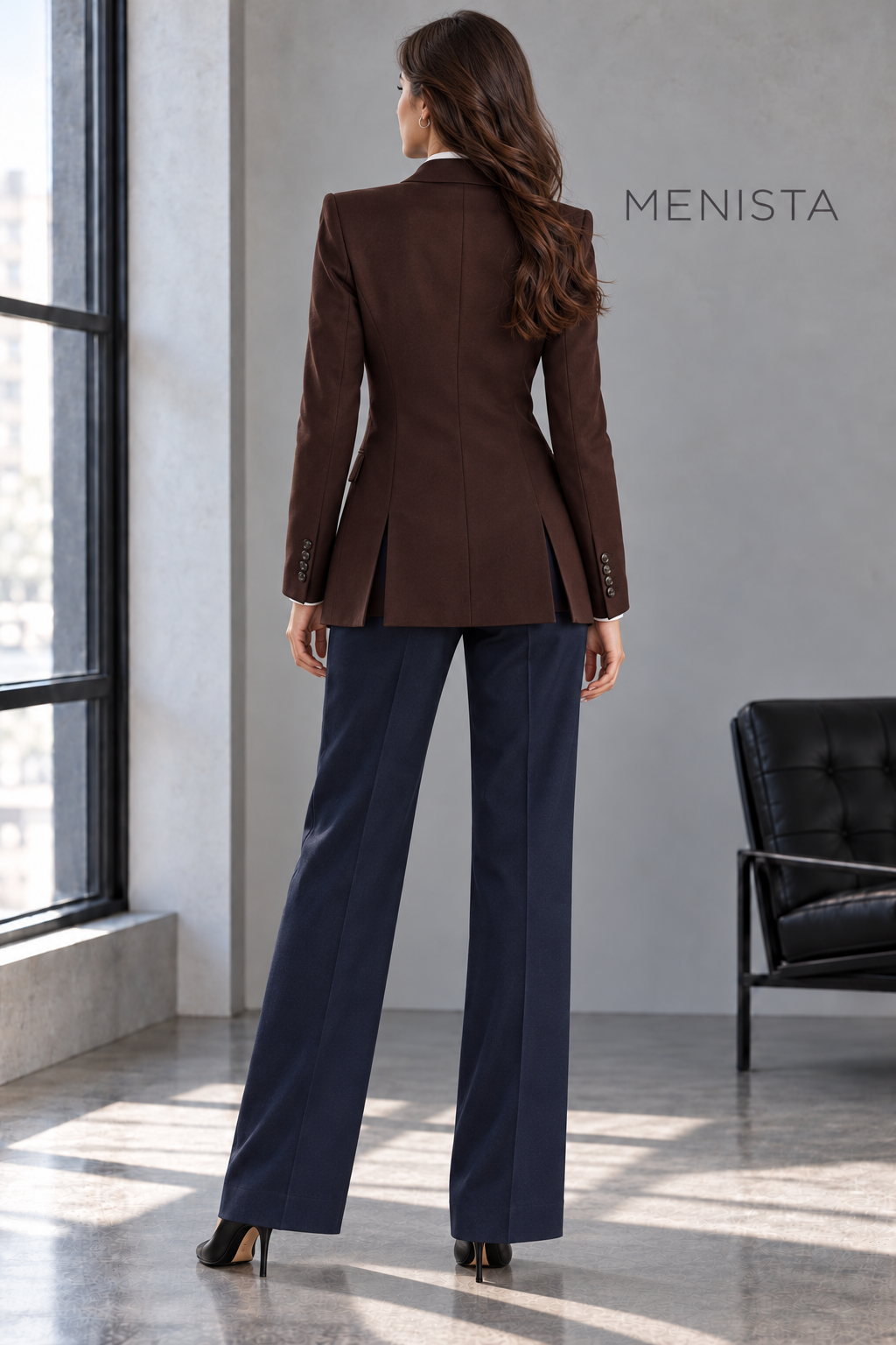 Back view of Evelina’s chocolate-brown jacket with twin side vents and navy trousers.