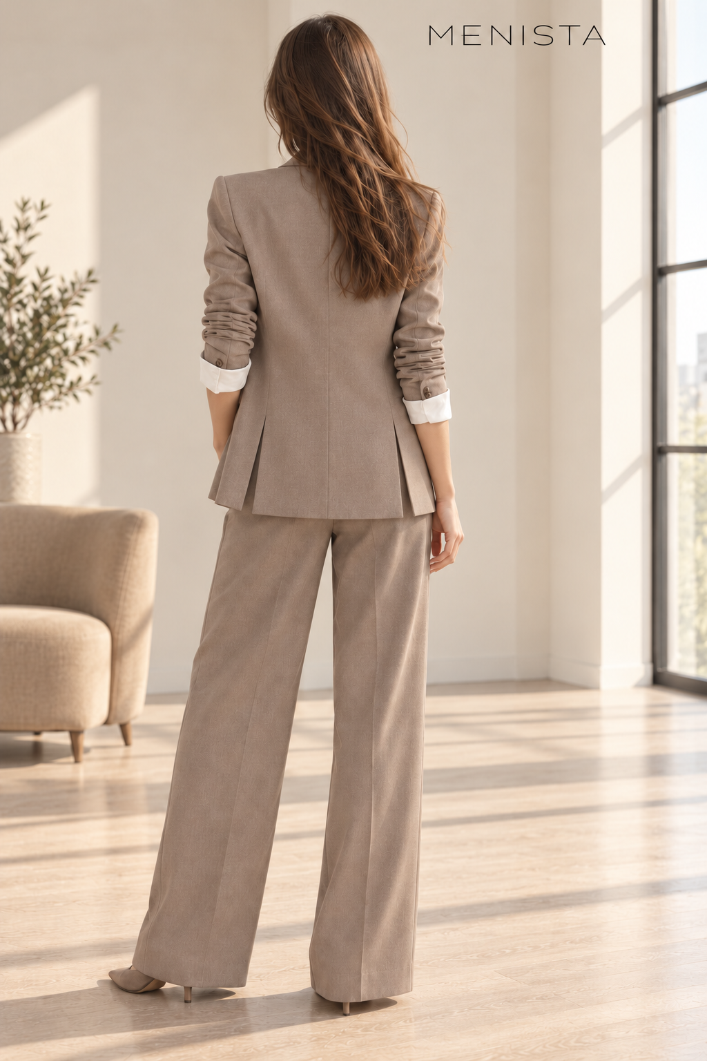 Back view of the taupe women’s blazer with twin side vents and matching wide-leg trousers.