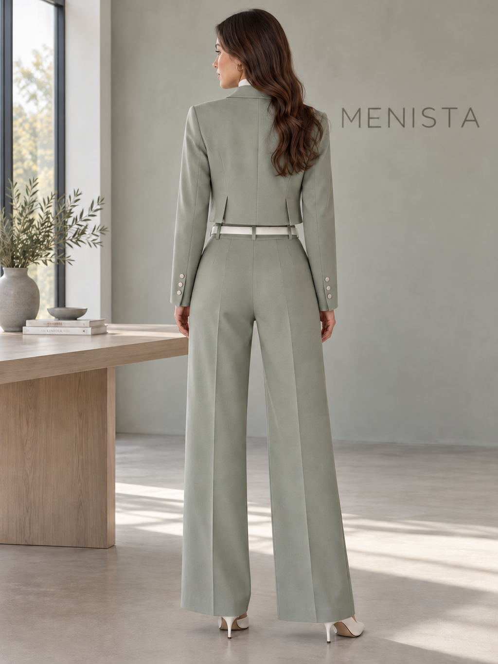 Rear view of women’s sage cropped single-button notch-lapel jacket and matching high-waisted wide-leg trousers, showing twin side vents.