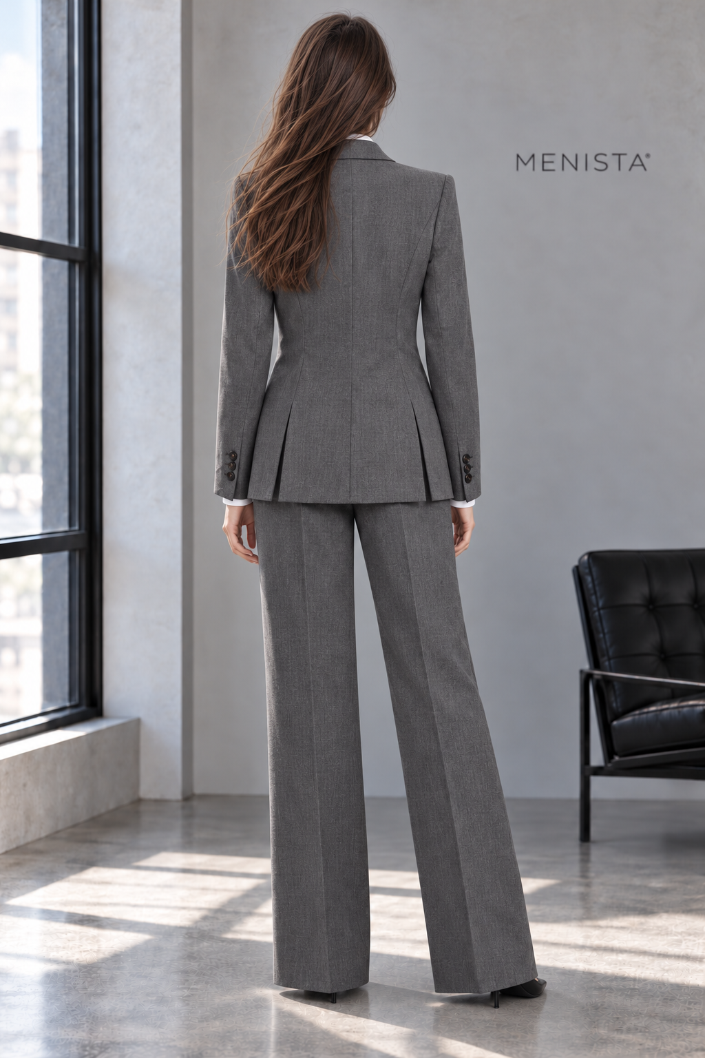 Back view of Elowen’s charcoal melange jacket with twin side vents and matching trousers.