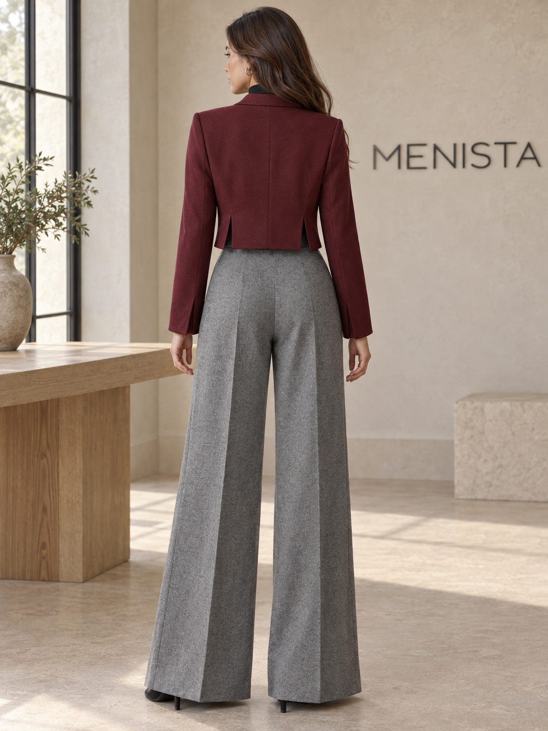 Rear view of women’s burgundy cropped jacket and grey melange wide-leg trouser set, showing the jacket’s twin side vents.