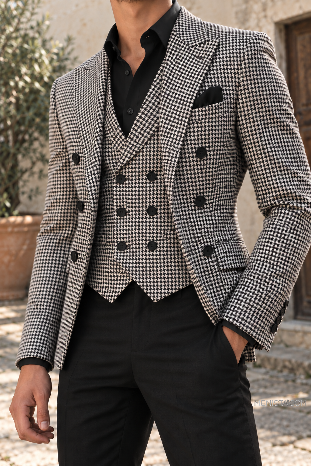 Close-up of Evaristo houndstooth double-breasted jacket and matching six-button vest over a black formal shirt.