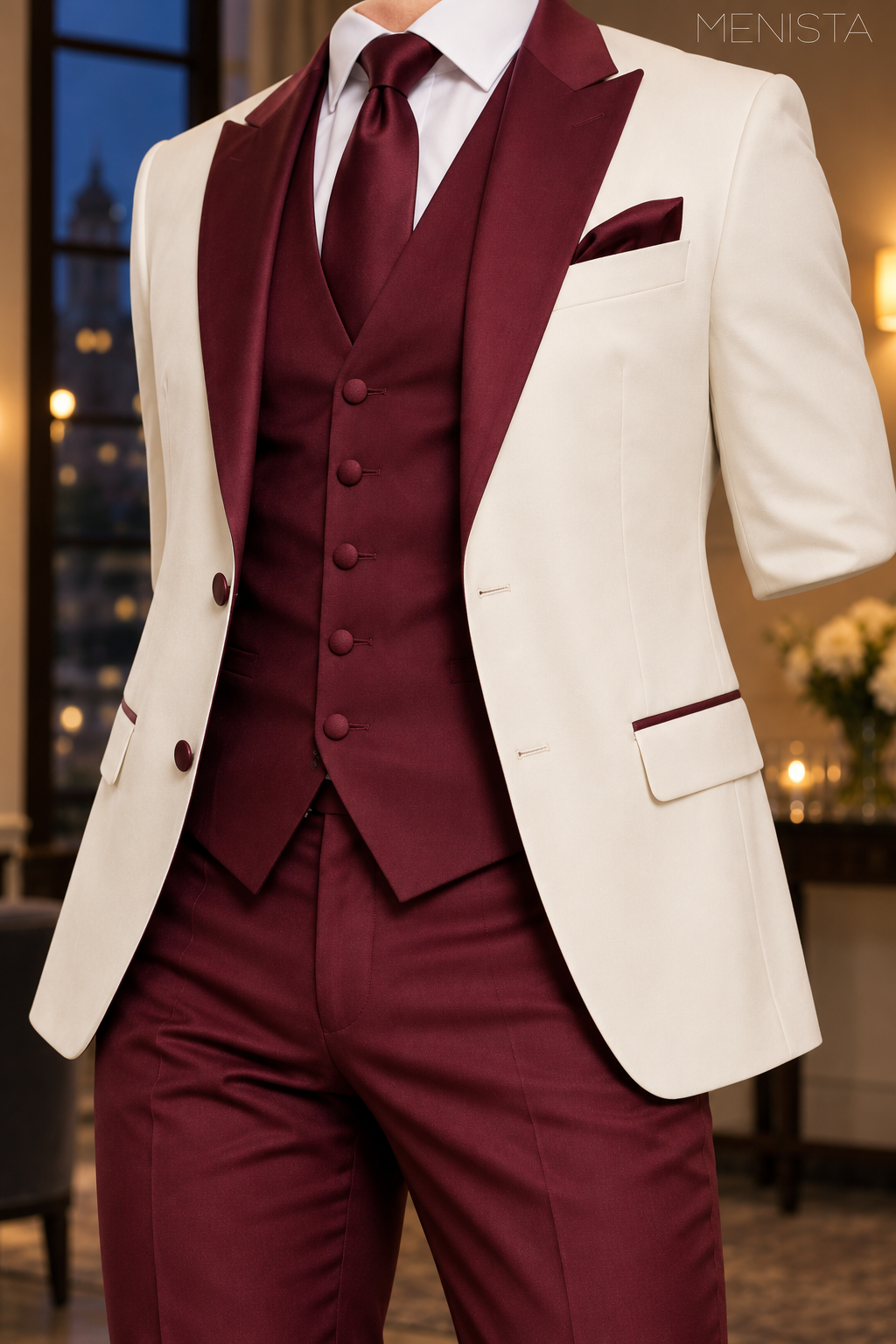 Close-up of ivory two-button jacket, burgundy peak lapels and five-button burgundy waistcoat.