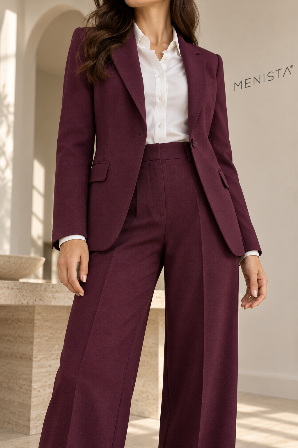 Close-up of women’s deep plum single-button jacket and matching wide-leg trousers, showing lapels and tailored construction.
