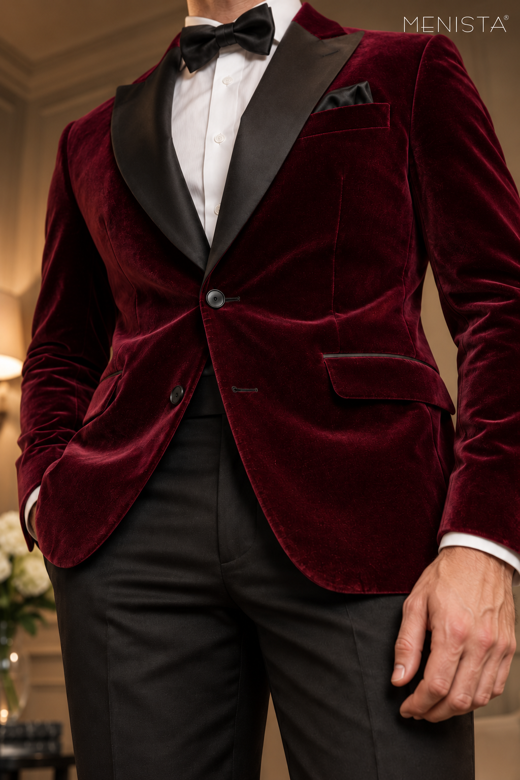 Close-up of Menista maroon velvet suit showing black peak lapels, two black front buttons and velvet texture.