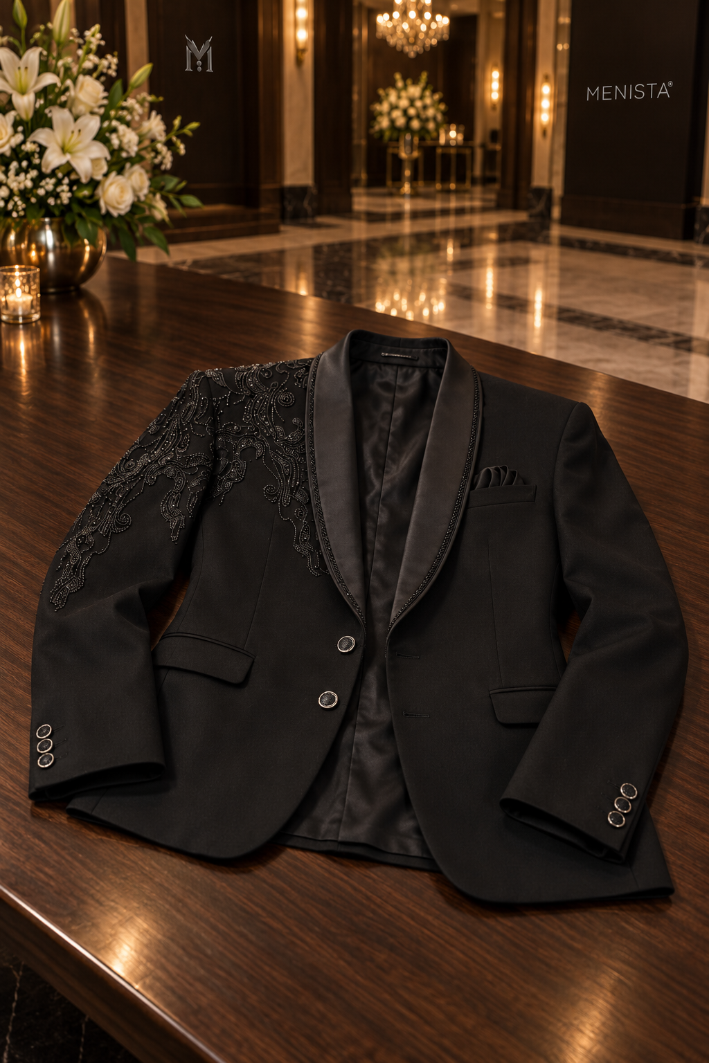 Alder two-button black paisley tuxedo jacket laid flat on a wooden table