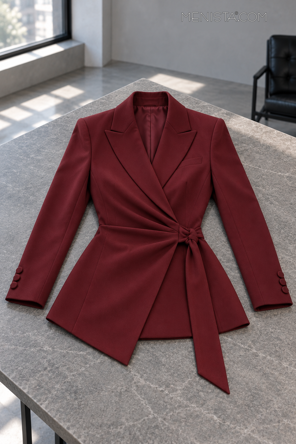 Lucienne jacket spread flat on a stone table with both sleeves supported.