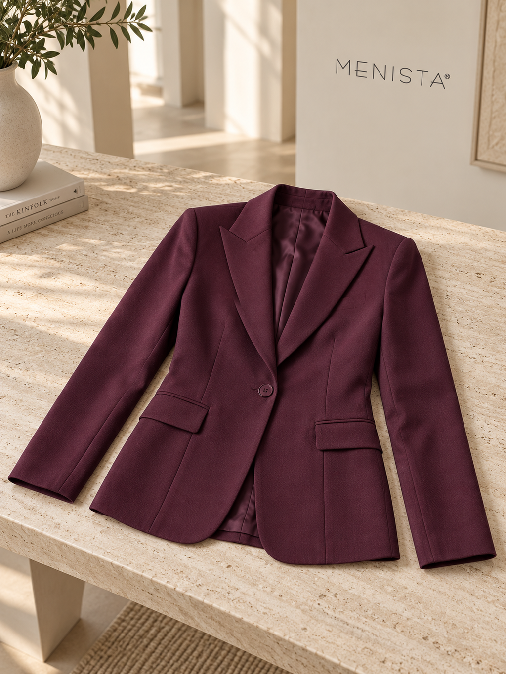 The jacket from the women’s deep plum single-button jacket and matching wide-leg trousers, arranged flat with naturally supported sleeves.