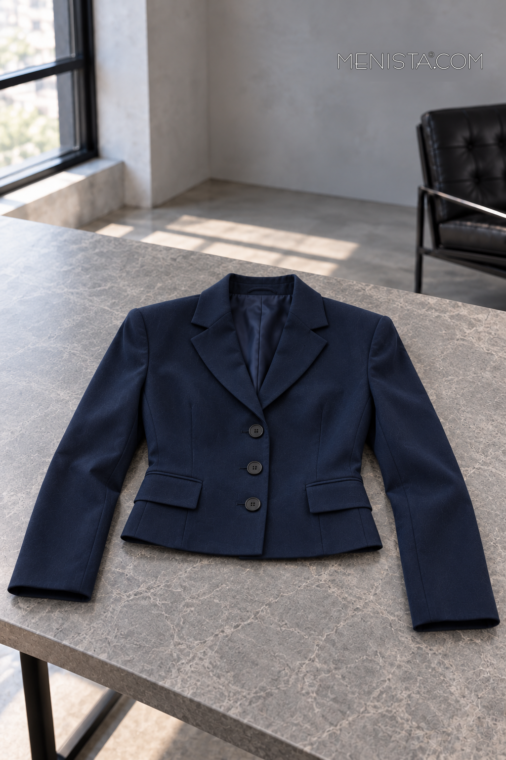 Calista jacket spread flat on a stone table with both sleeves supported.
