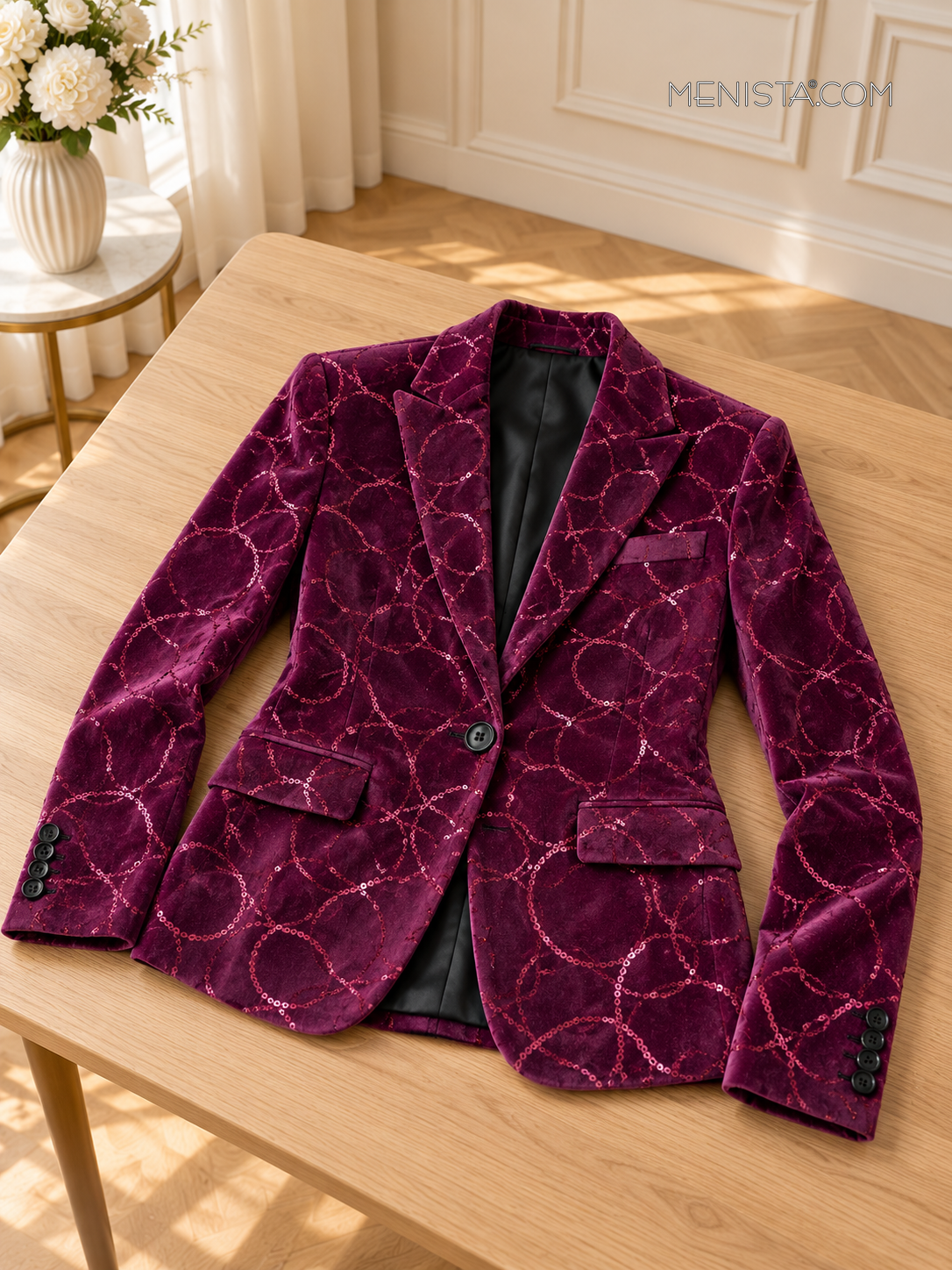Purple circle-sequin single-breasted jacket spread flat on a broad wooden table with both sleeves supported.