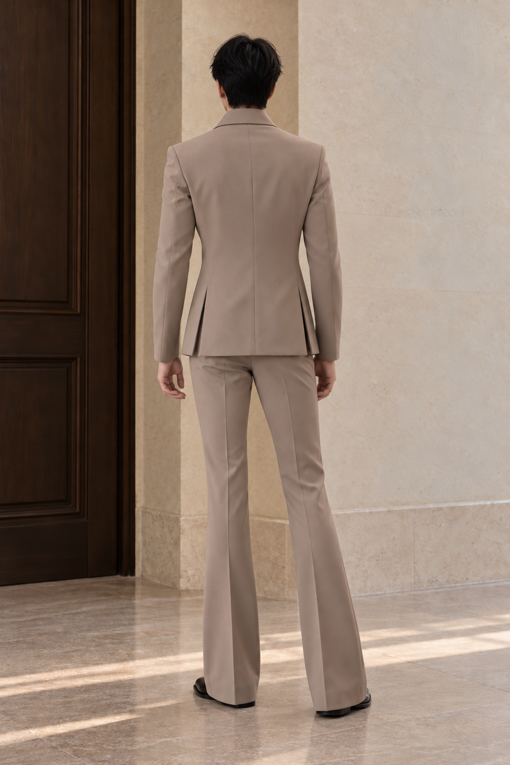 Full back view of the Elouan taupe jacket with two side vents and matching flared trousers on Kevin.