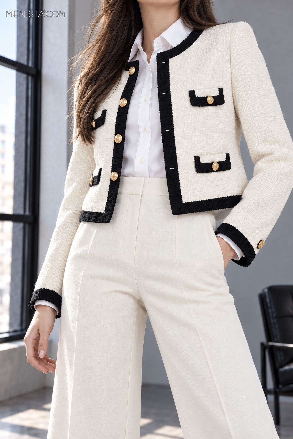 Close-up of Odeline jacket black trim, four gold front buttons, pocket flaps and textured fabric.