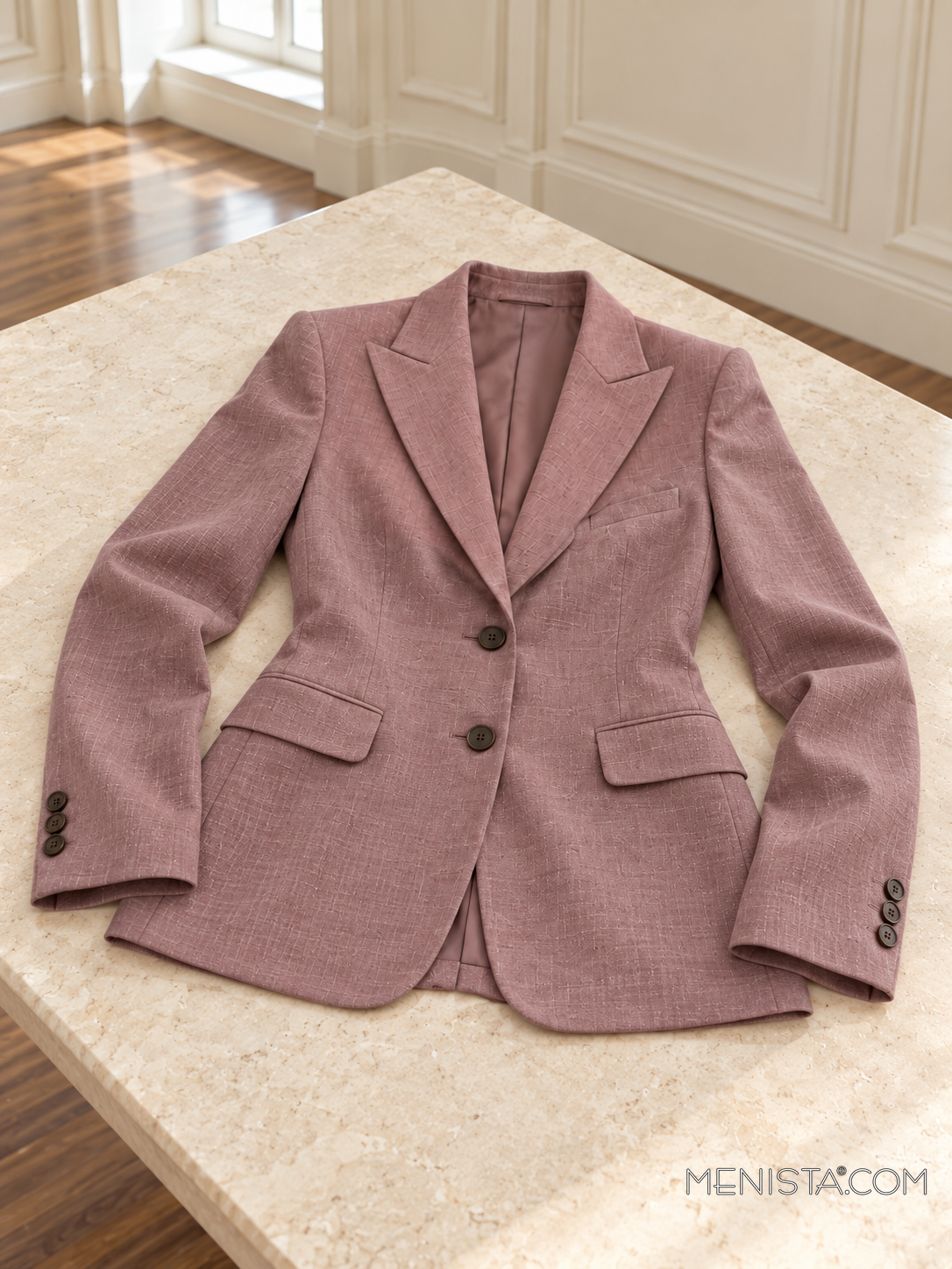 Seraphine muted mauve linen jacket laid flat and spread on a stone table with both sleeves supported.