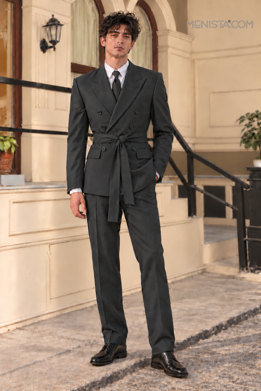 Bruce wearing the Benicio charcoal double-breasted 2PC suit with six buttons and matching sash, front view without a pin.