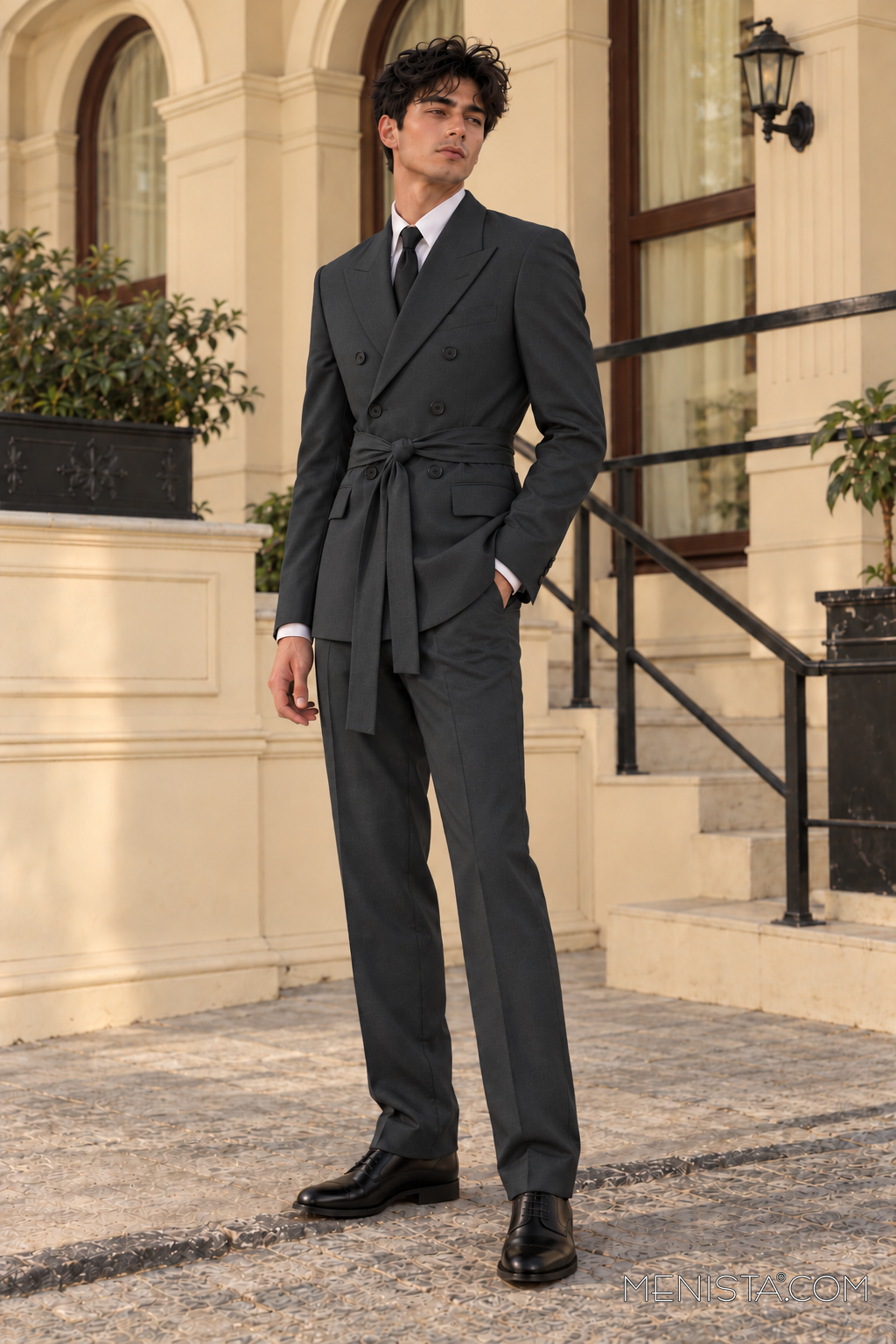 Bruce wearing the Benicio charcoal double-breasted 2PC suit with matching sash, standing three-quarter view.